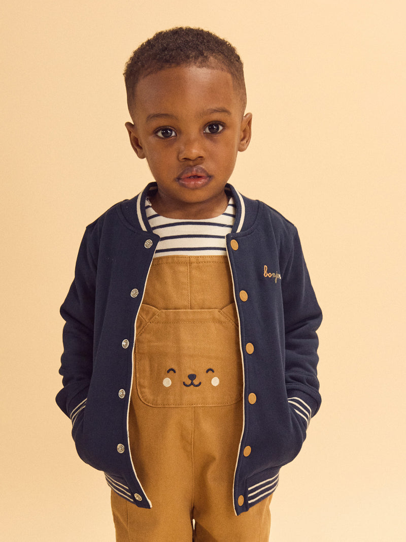 Reversibler Teddy in Marineblau oder Elfenbein mit Hundemuster für Baby Jungen